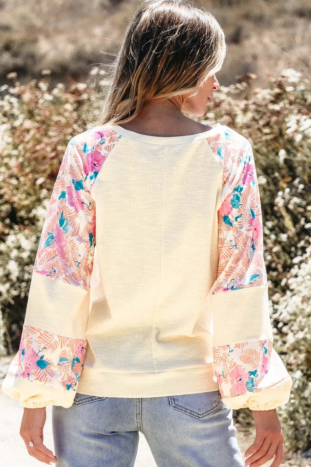 Printed round neck balloon sleeve blouse with floral design, featuring a basic style and slightly stretchy material.