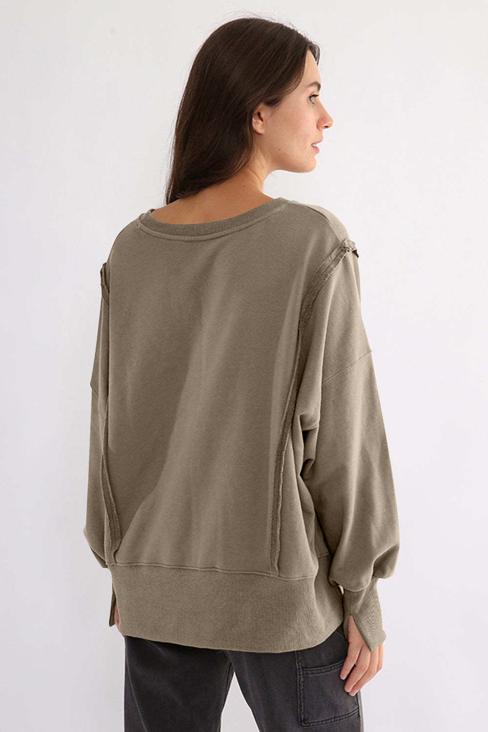 Exposed seam high-low long sleeve sweatshirt in olive green color.