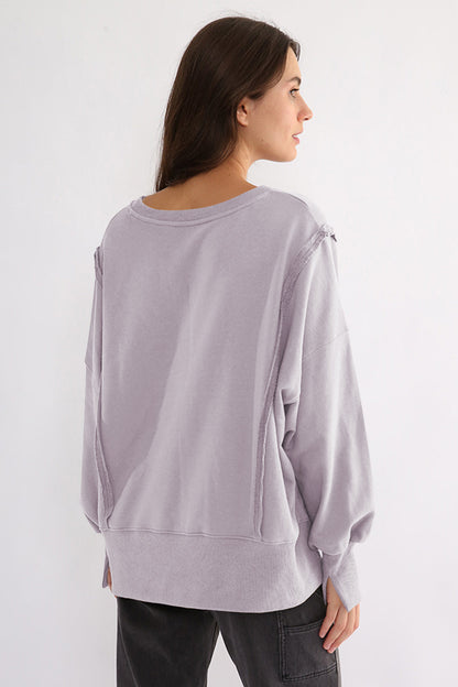 Exposed seam high-low long sleeve sweatshirt with slits, 100% cotton, slightly stretchy, in lilac color.