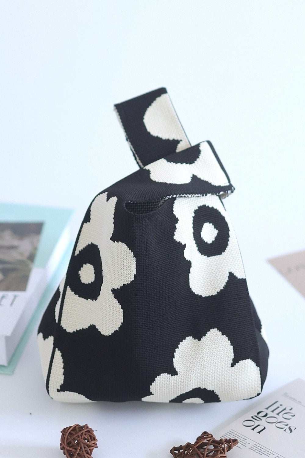 Black and white flower eco-friendly knitted handbag with floral design.