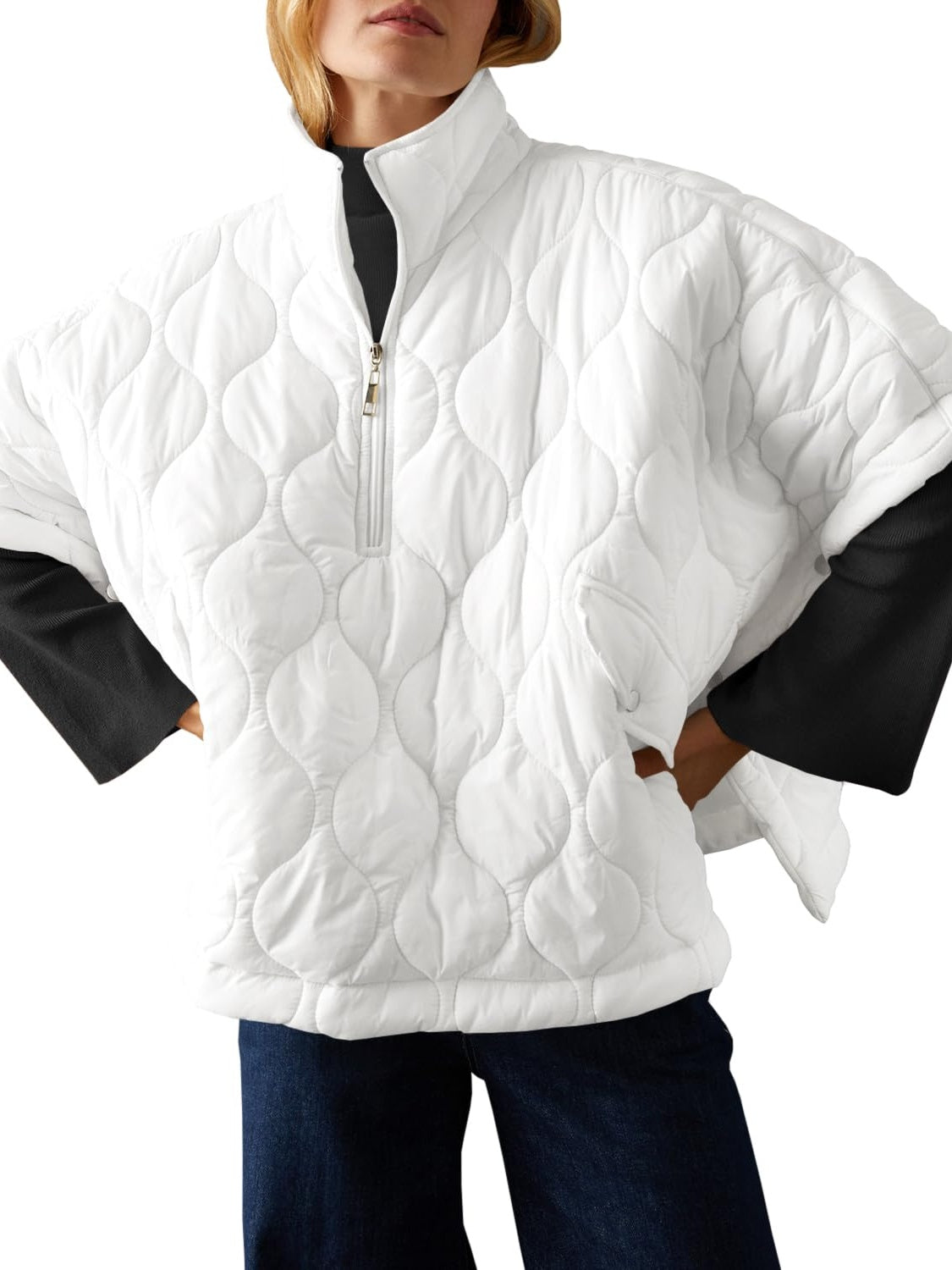 Textured white half zip pullover poncho, lined and made of 100% polyester.