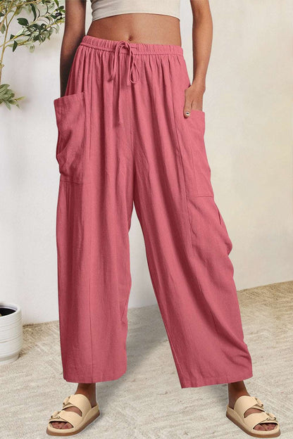 Boho wide leg harem pants with pockets in pink, 100% polyester.