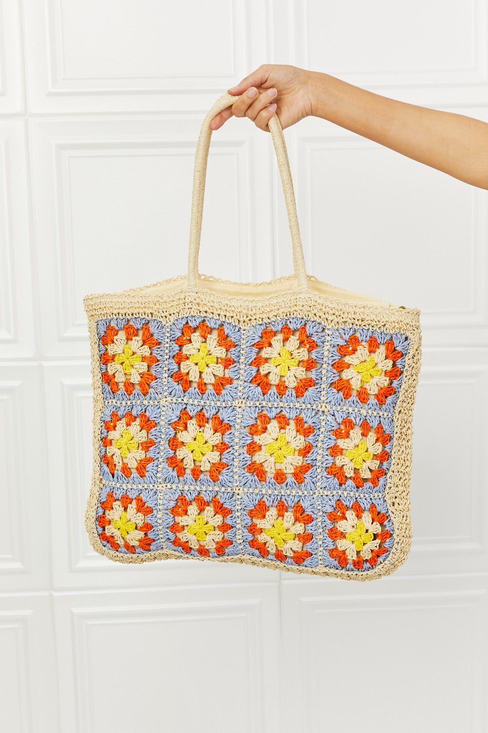 Large straw tote bag with crochet design, embroidery pattern, and long straps for versatile use.