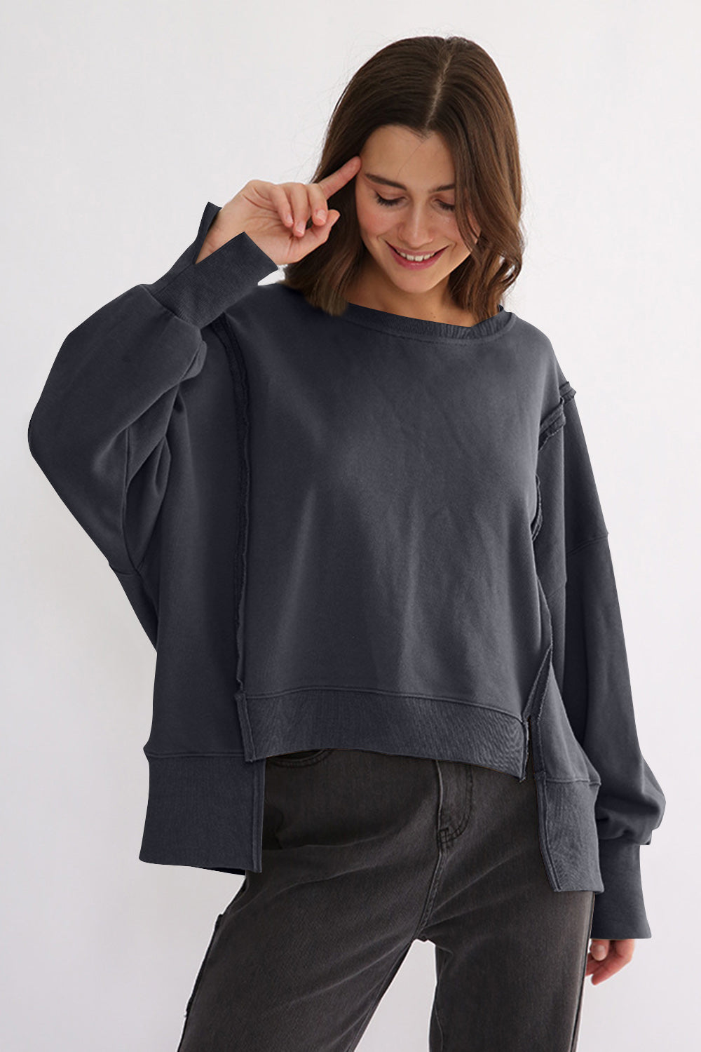 Exposed seam high-low long sleeve sweatshirt with slit, 100% cotton, slightly stretchy.