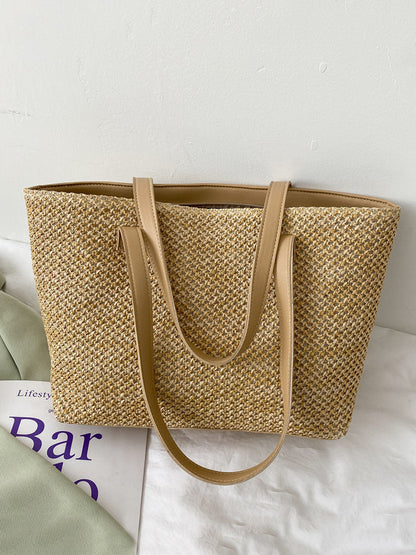 Solid color woven tote bag, medium size, beige with handles.