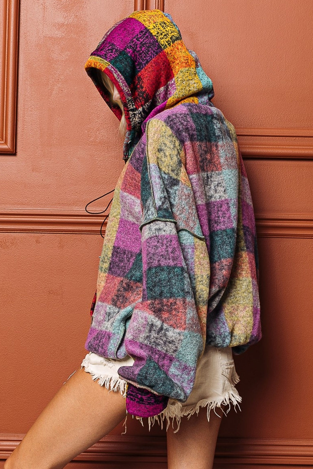 Colorful boho patchwork fleece hoodie with exposed seams and half zip design.