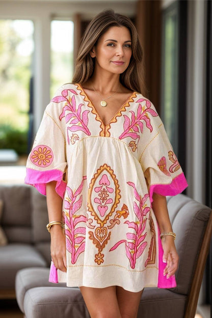 Printed V-neck three-quarter sleeve mini dress with colorful floral patterns.