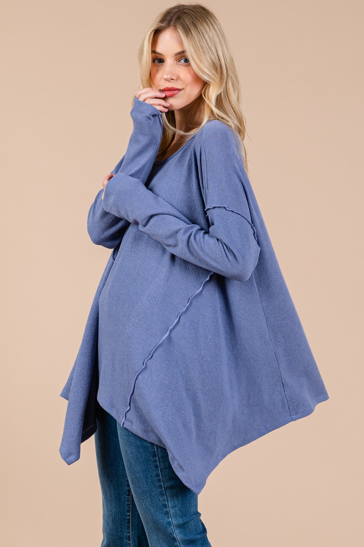 Oversized asymmetrical long sleeve top with drop sleeve and hi-low hem in soft, stretchy knit fabric.