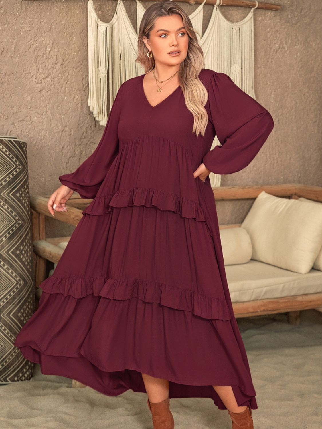 Plus size ruffled V-neck long sleeve dress in burgundy, 100% viscose material, modeled in an indoor setting.