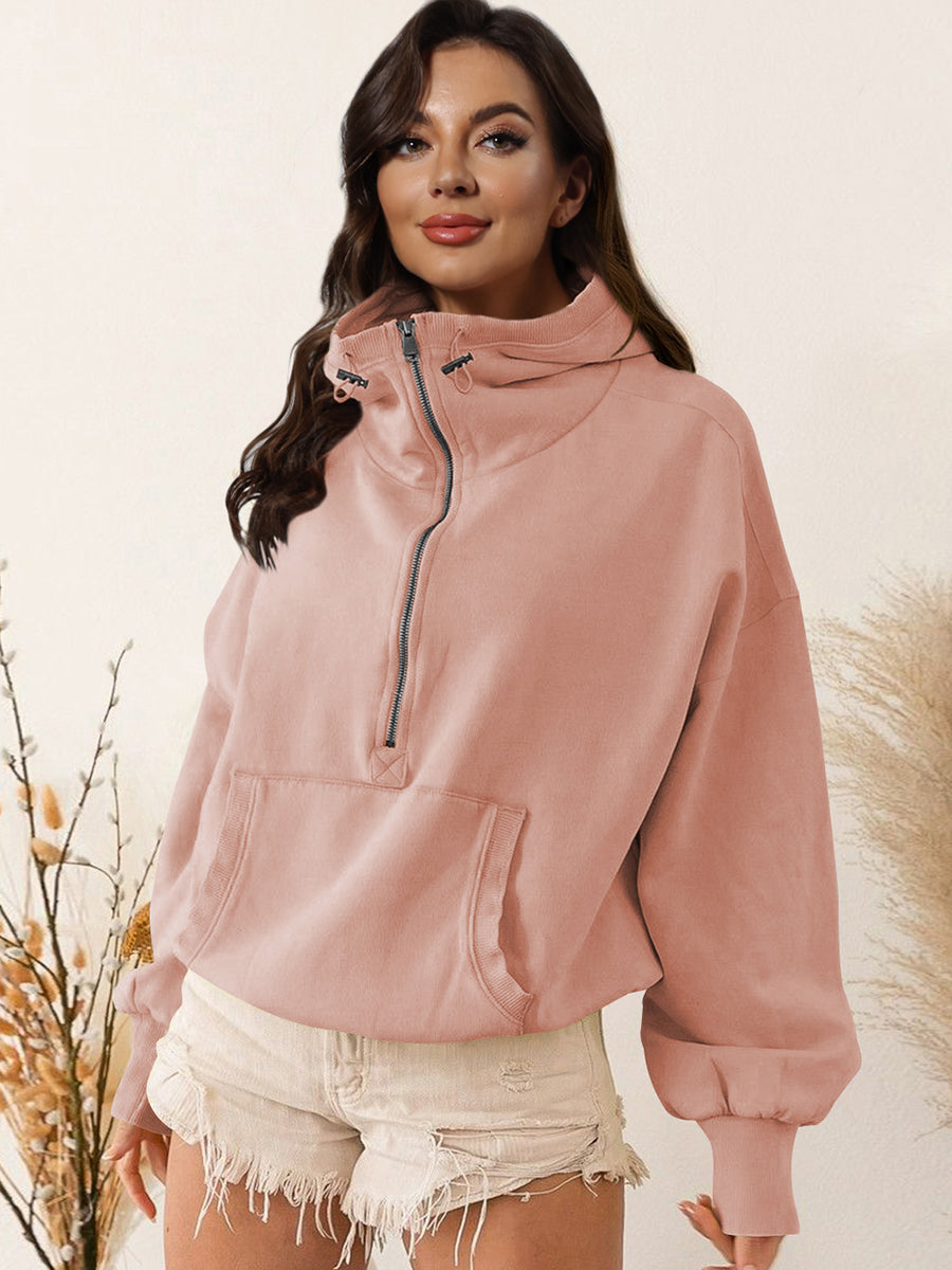 Pink zip-up dropped shoulder hoodie with drawstring and pocket, made of polyester and rayon.