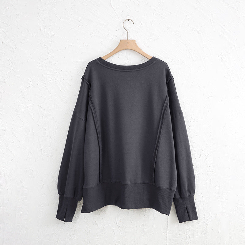 Exposed seam high-low long sleeve sweatshirt.