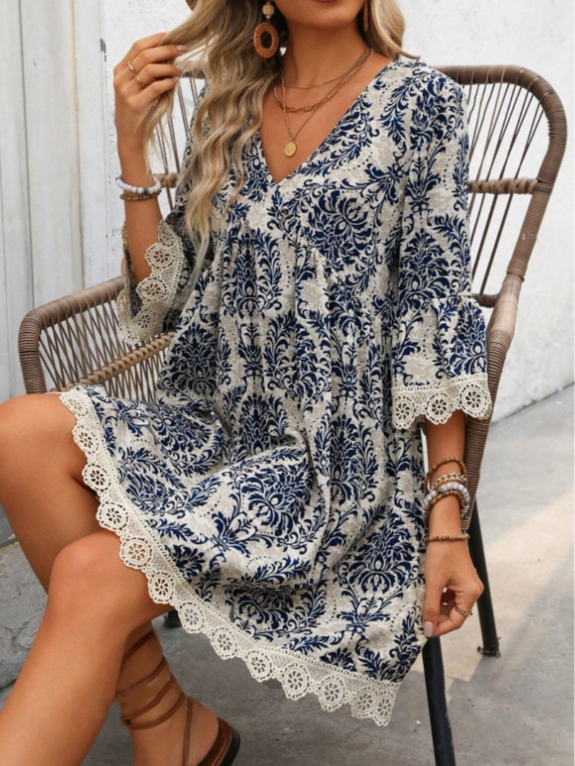 Lace detail printed V-neck mini dress with floral patterns in blue and beige.