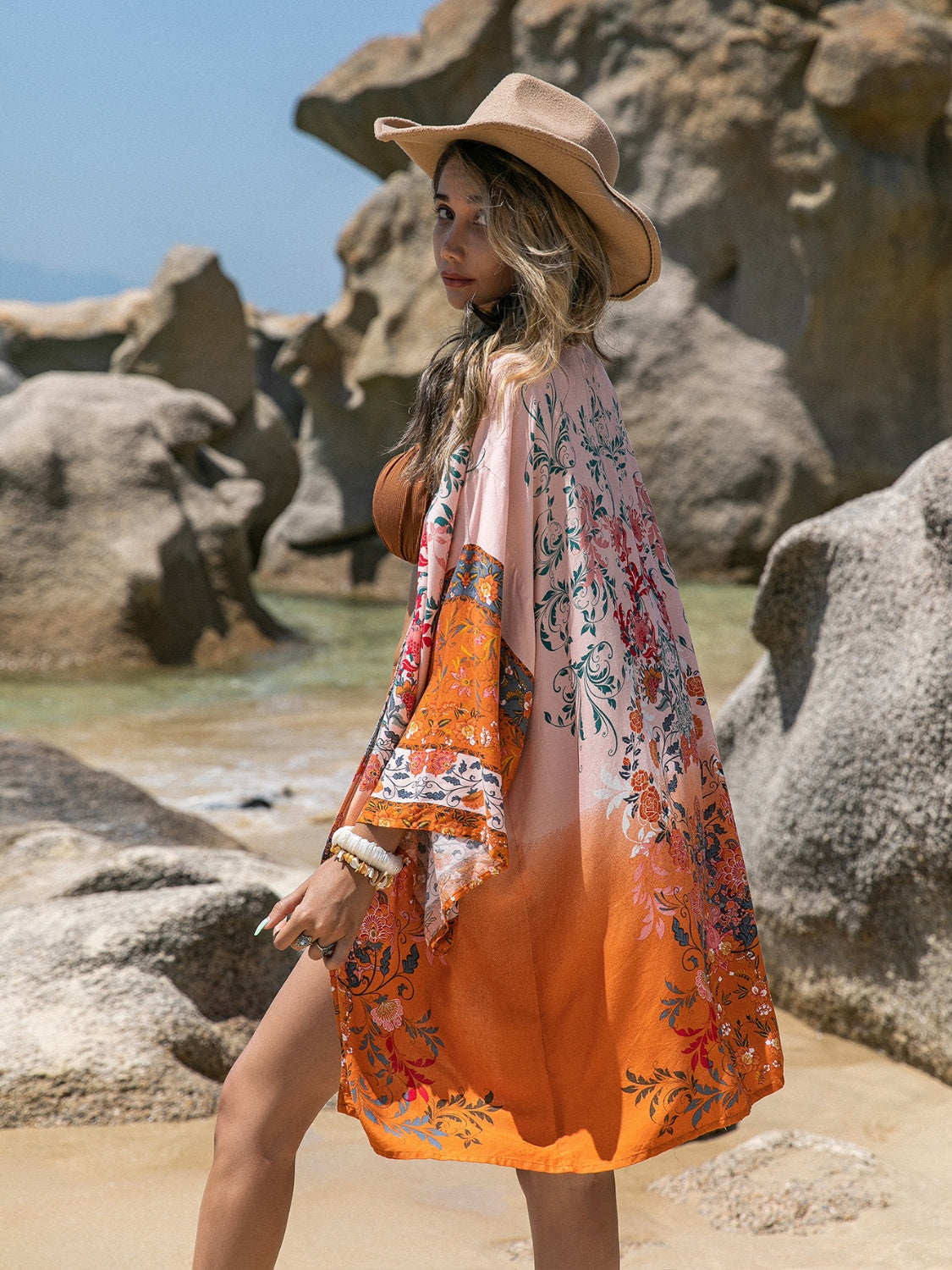 Printed open front long sleeve cover-up on the beach.