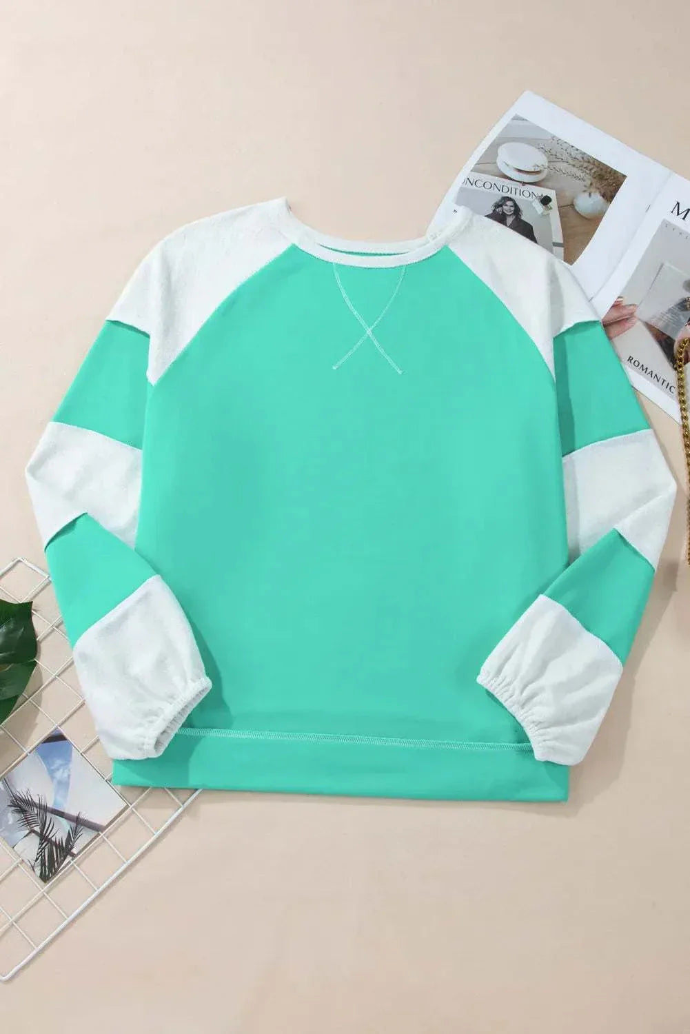 Plus size color block long sleeve sweatshirt with exposed seam design.