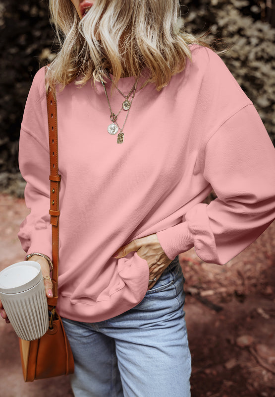 Round Neck Long Sleeve Sweatshirt in pink, styled with a casual outfit.