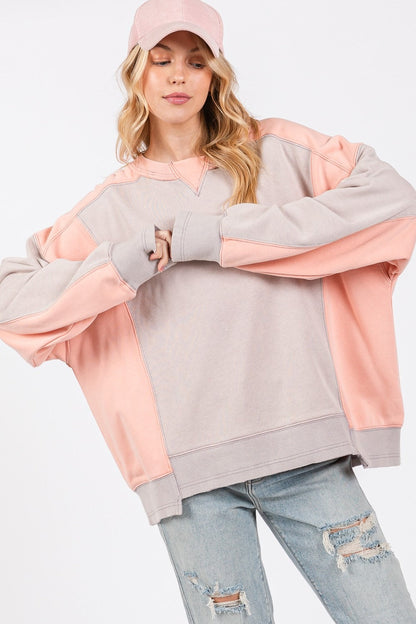 Color block round neck relaxed fit sweatshirt with ribbed trim, dropped sleeves, and seaming details.