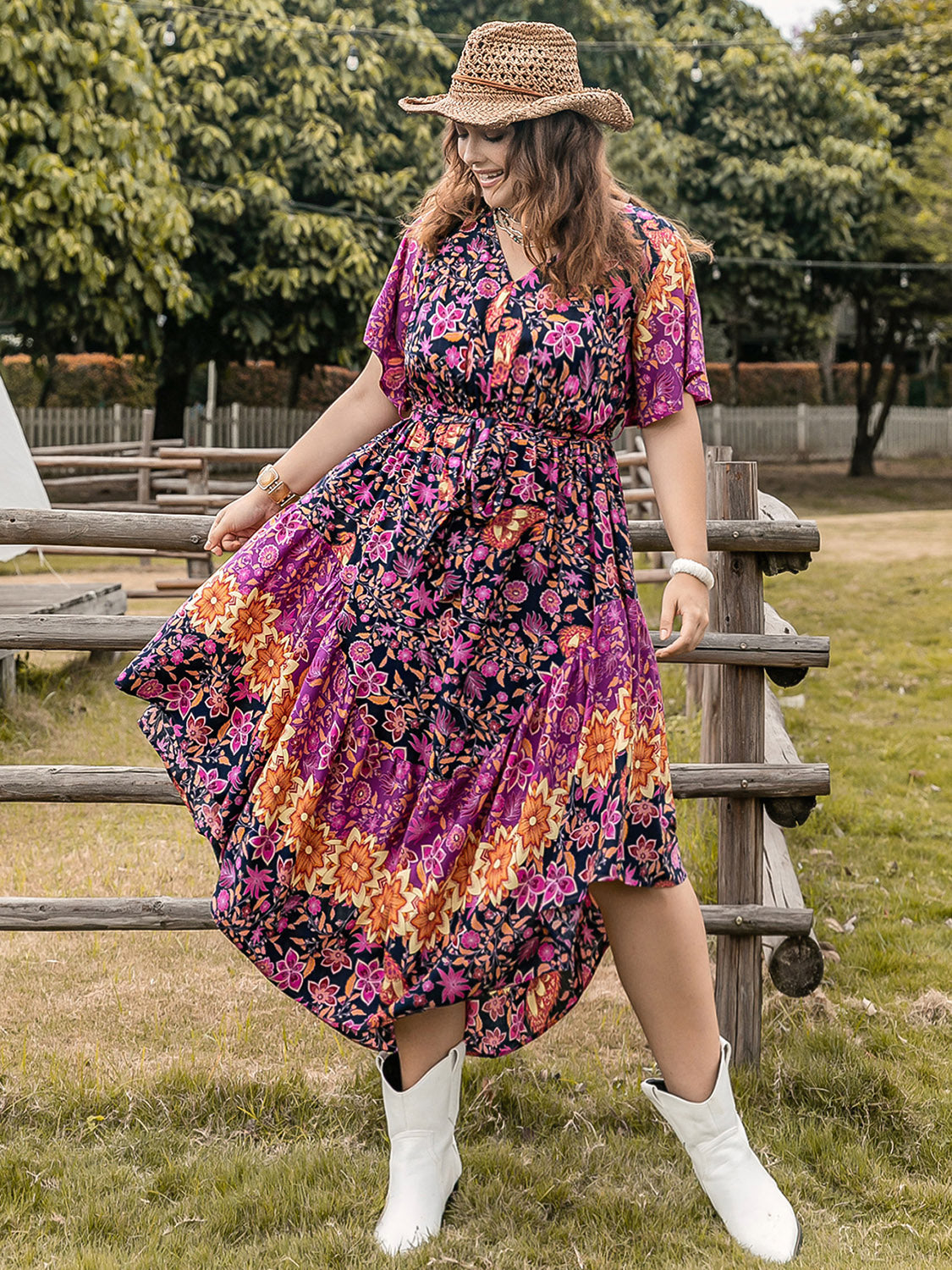 Plus size printed V-neck flutter sleeve midi dress in vibrant colors.