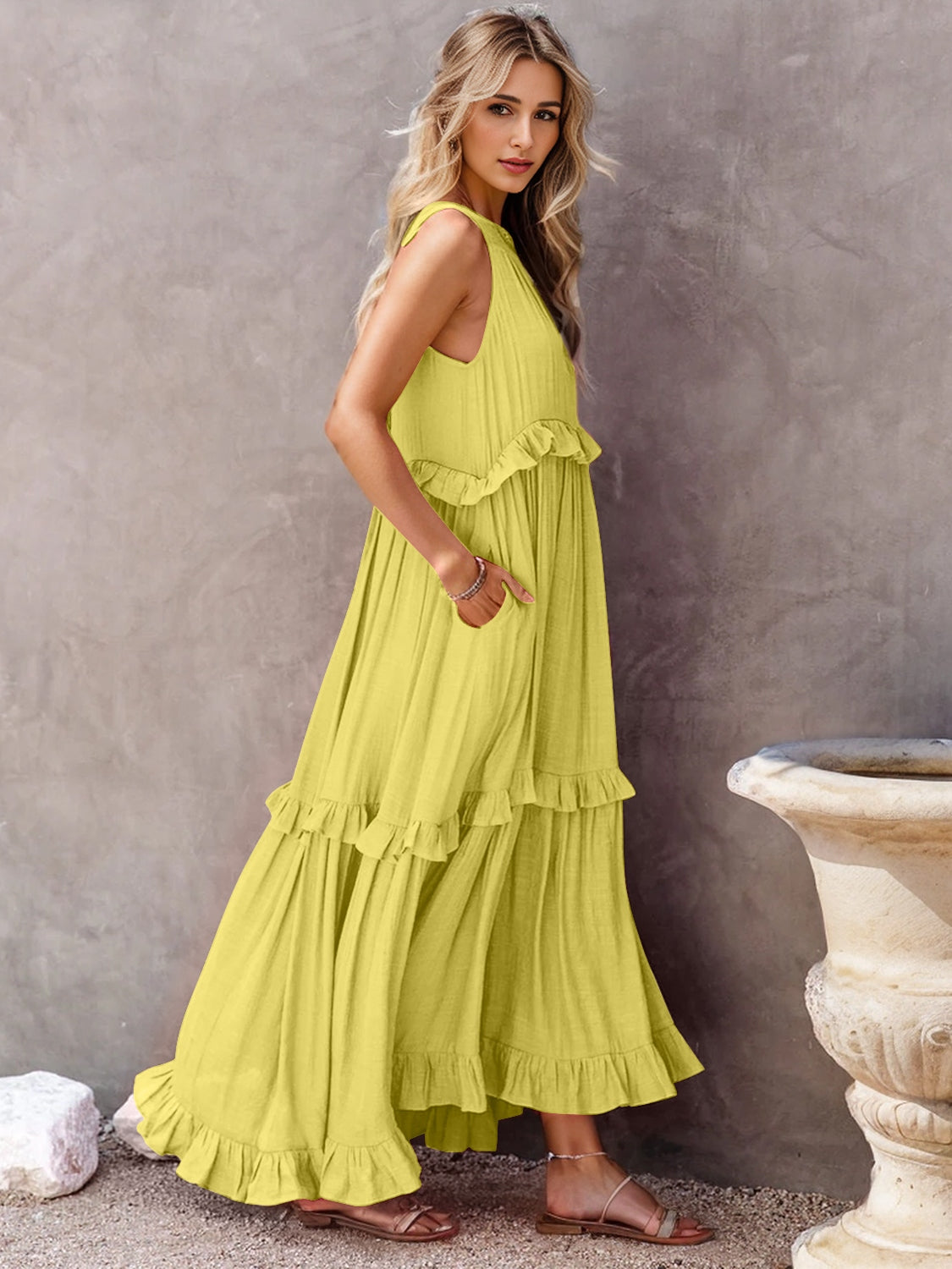 Ruffled sleeveless tiered maxi dress with pockets in a vibrant yellow color.