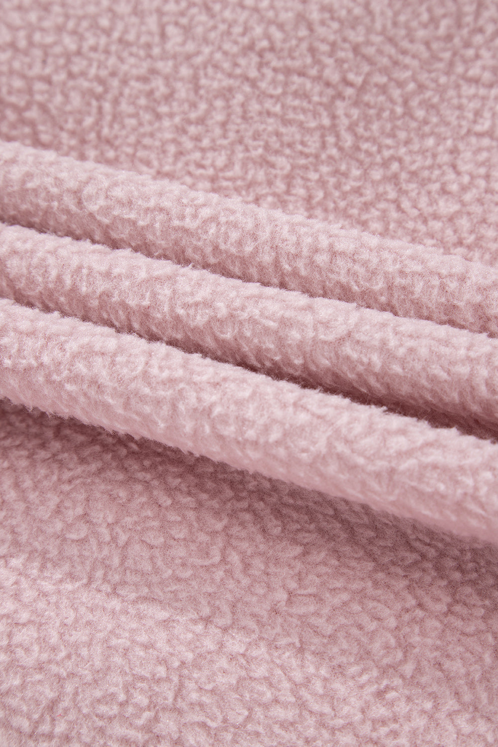 Close-up of pink fleece fabric from a Half Snap Long Sleeve Fleece Jacket.