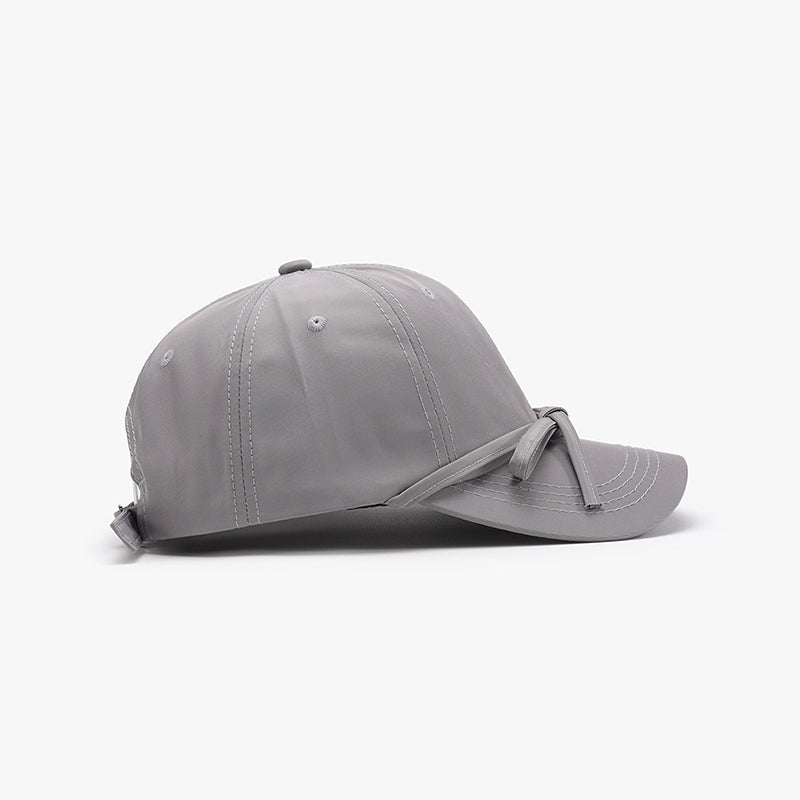 Women's cotton baseball cap with tied bow design, gray color.