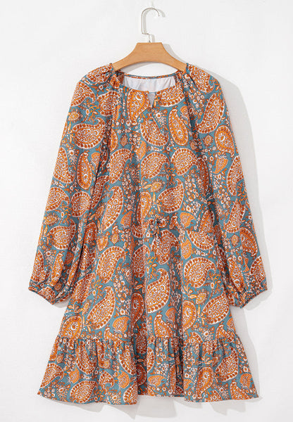 Ruffle hem printed long sleeve dress in orange and blue paisley pattern.