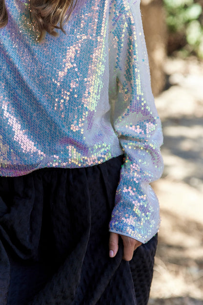 Sequin long sleeve crop top with shimmering details.