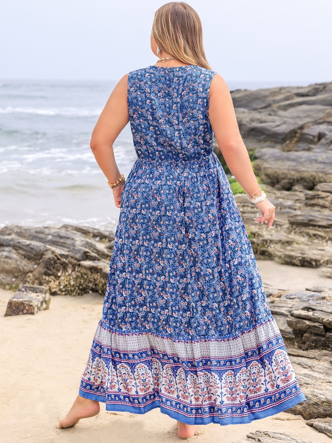 Plus size tied printed sleeveless maxi dress, blue pattern, beach background.