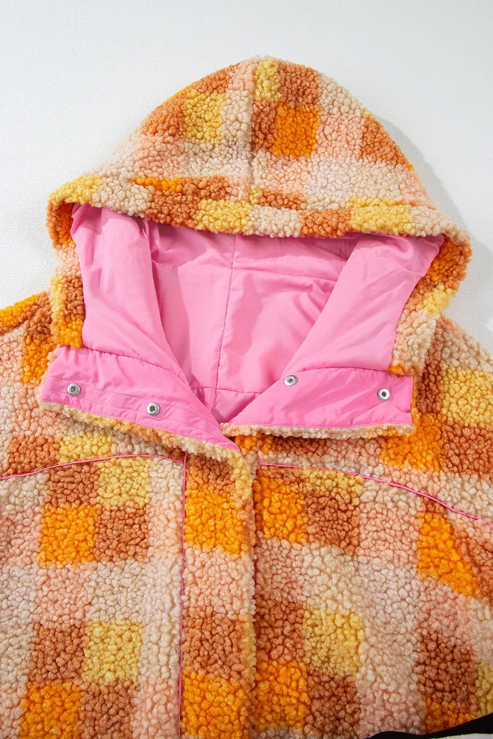 Plaid long sleeve hooded jacket with pink lining and orange check pattern.