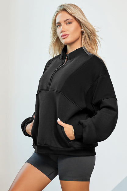 Oversized black half zip dropped shoulder sweatshirt with pockets.