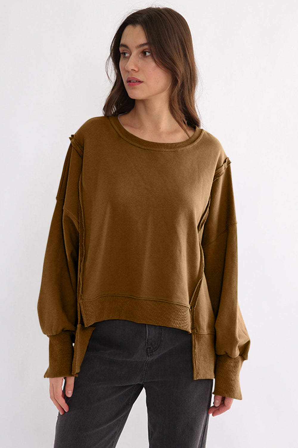 Exposed seam high-low long sleeve sweatshirt in brown, featuring slit design, made from 100% cotton.