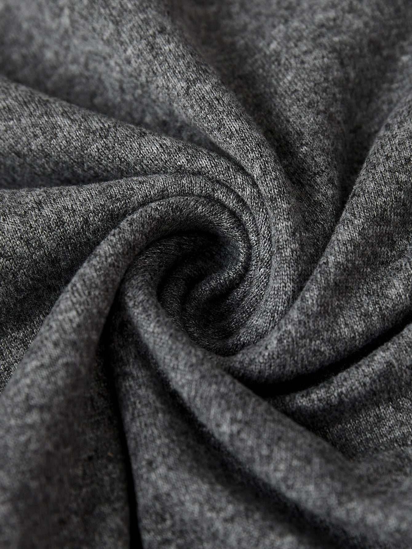 Close-up of soft, stretchy polyester fabric in charcoal gray for a graphic t-shirt featuring "Grateful Thankful Blessed."