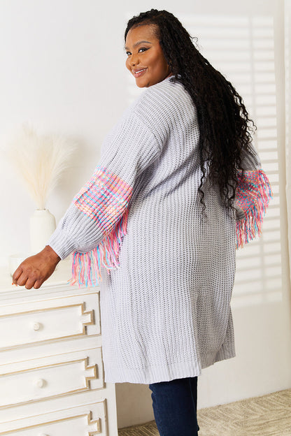 Woven fringe sleeve dropped shoulder cardigan in boho style with colorful woven fringe details.