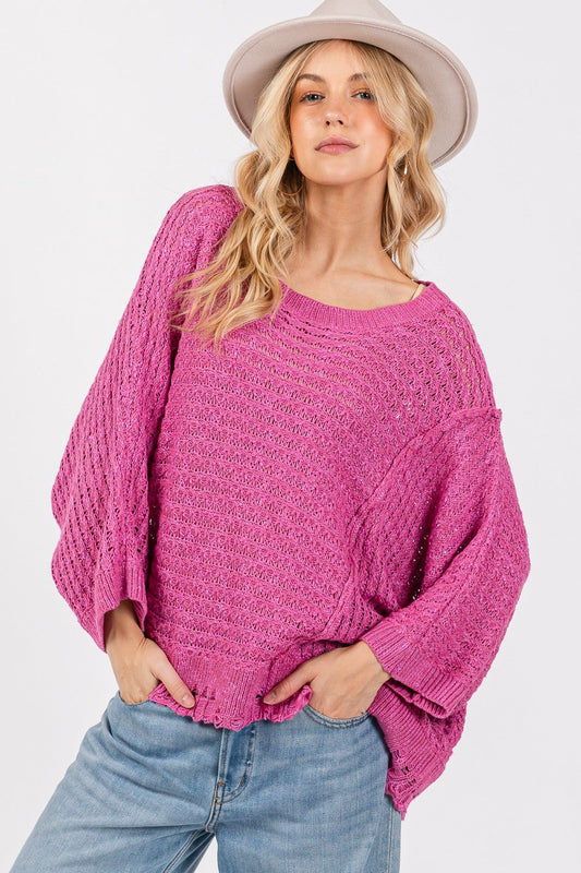 Distressed asymmetrical open stitch sweater in magenta with half sleeves and round neckline.