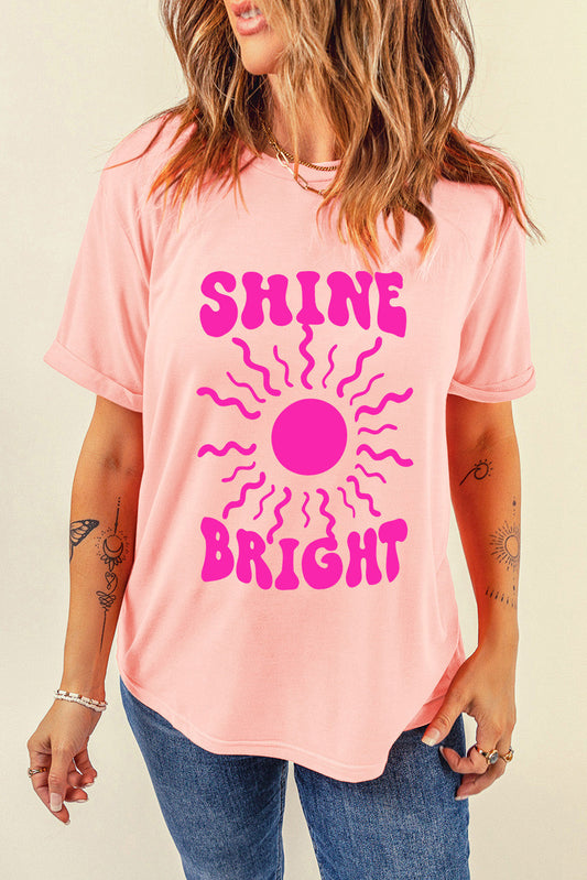 Shine Bright Graphic T-Shirt in pink with sunburst design, casual fit.