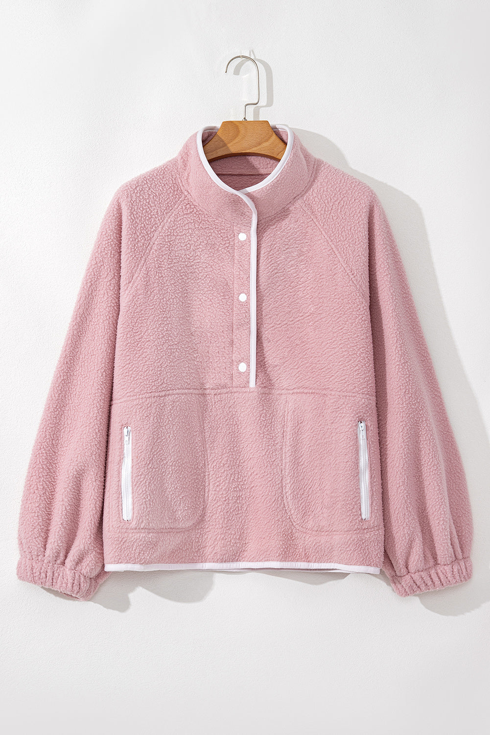 Pink half snap long sleeve fleece jacket with pockets, polyester material.