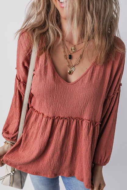 Boho frill long sleeve blouse with V-neck in rust color, slightly stretchy fabric.