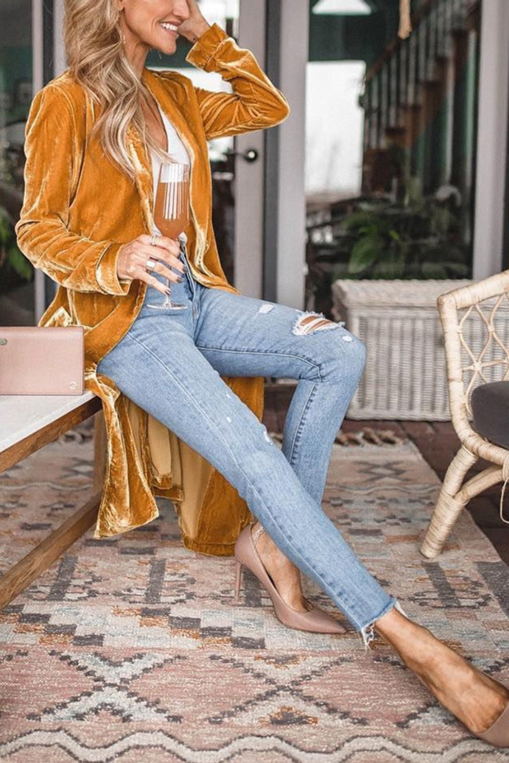 Open front long sleeve coat in mustard, paired with ripped jeans and heels.