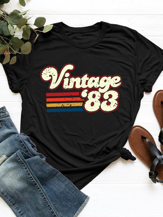 Vintage '83 Graphic T-Shirt with retro design and colorful stripes on black fabric.