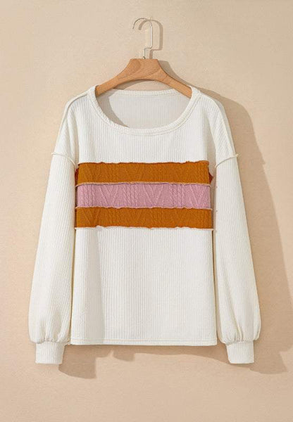 Color block long sleeve sweatshirt with white base and multicolor stripes on hanger.