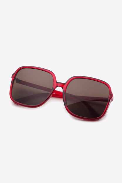 Red oversized square sunglasses with UV400 protection and polycarbonate frame.