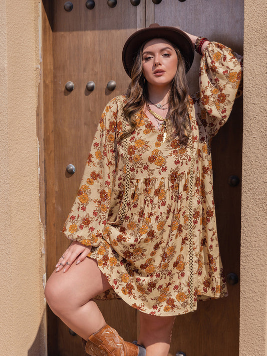 Plus size printed V-neck balloon sleeve mini dress in floral pattern.