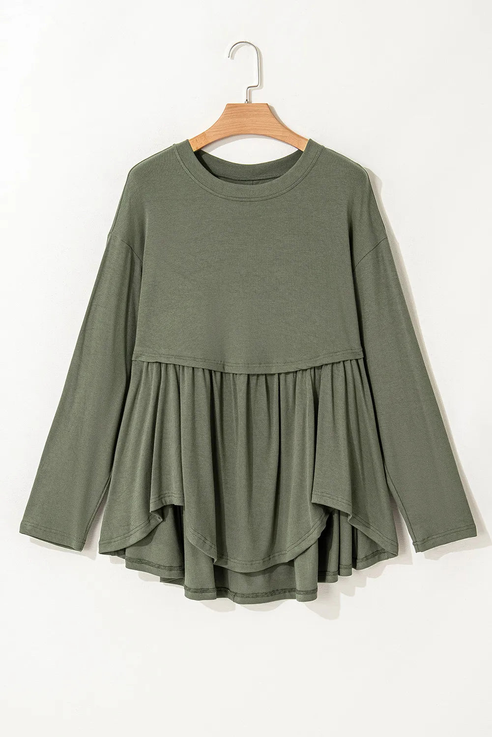 Plus size peplum round neck long sleeve blouse in green.