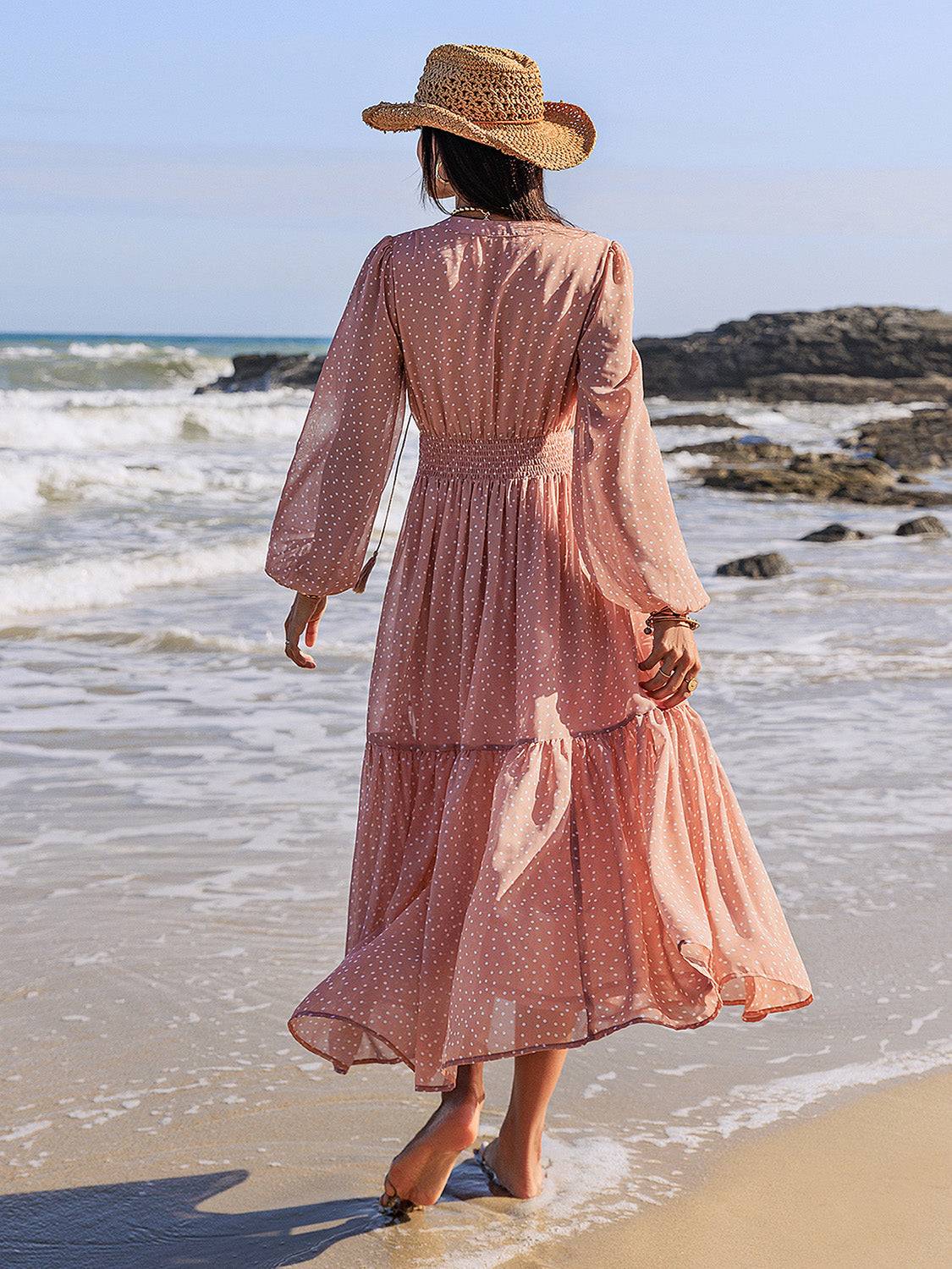 Embroidered polka dot tie neck long sleeve midi dress on beach.