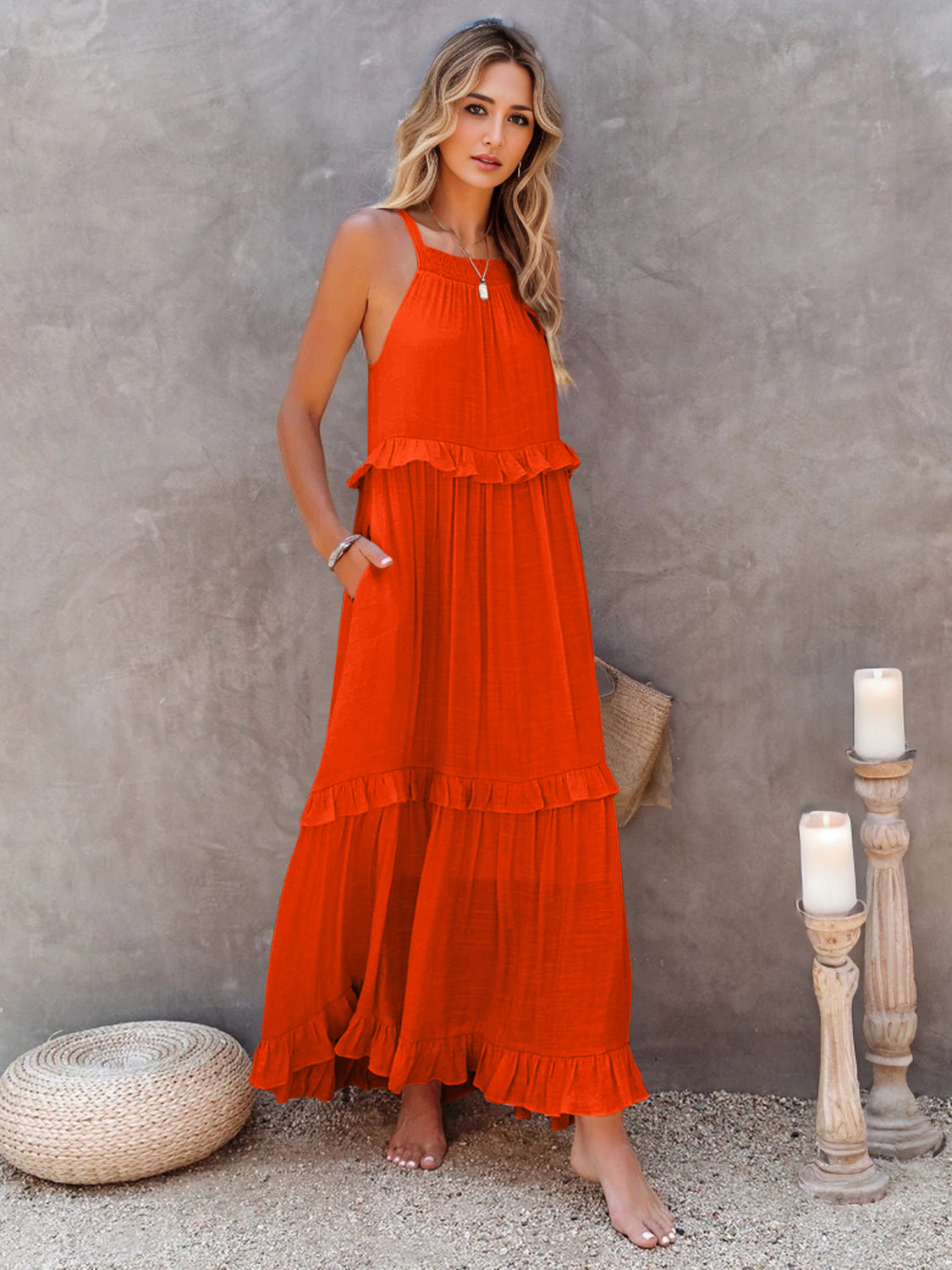 Ruffled sleeveless tiered maxi dress with pockets in vibrant orange.