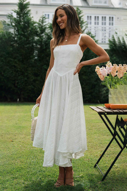 Square Neck Wide Strap Cami Dress in white cotton with ruffled design, worn by a woman in a garden setting.