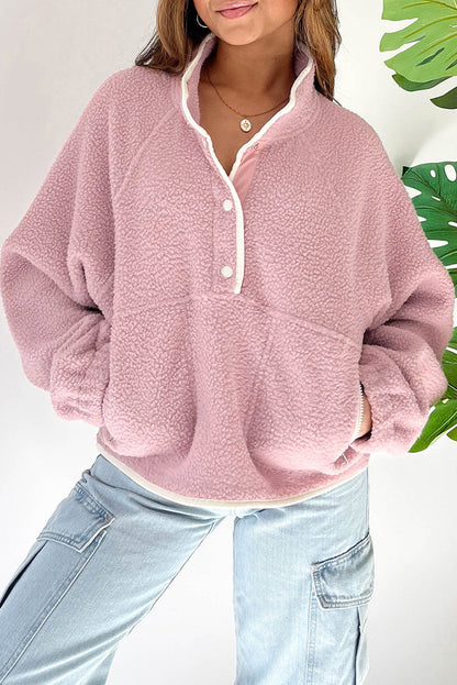 Pink half snap long sleeve fleece jacket with front pockets, 100% polyester.