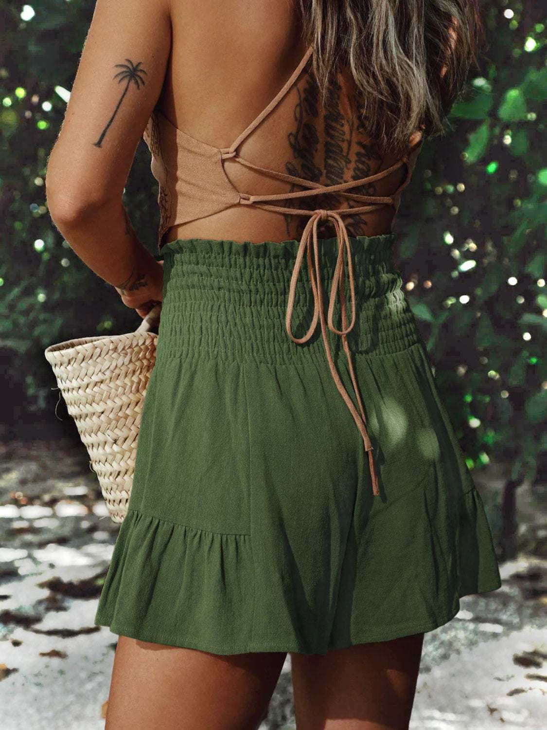 Bohemian shorts with ruffled high waist in green, smocked design.