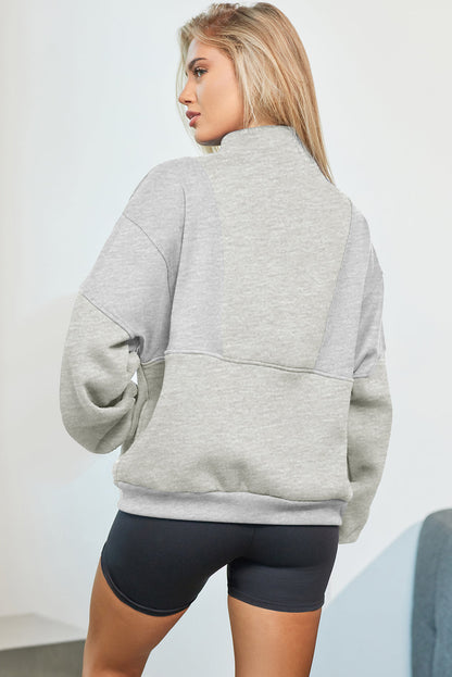 Oversized half zip dropped shoulder sweatshirt in grey, back view.