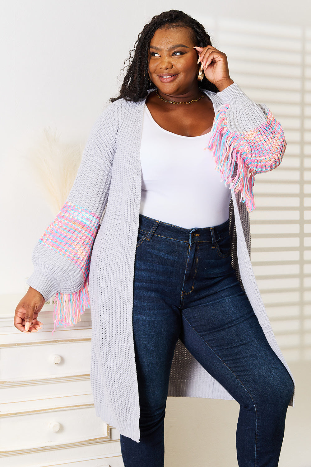 Boho style cardigan with fringe sleeves and dropped shoulders.