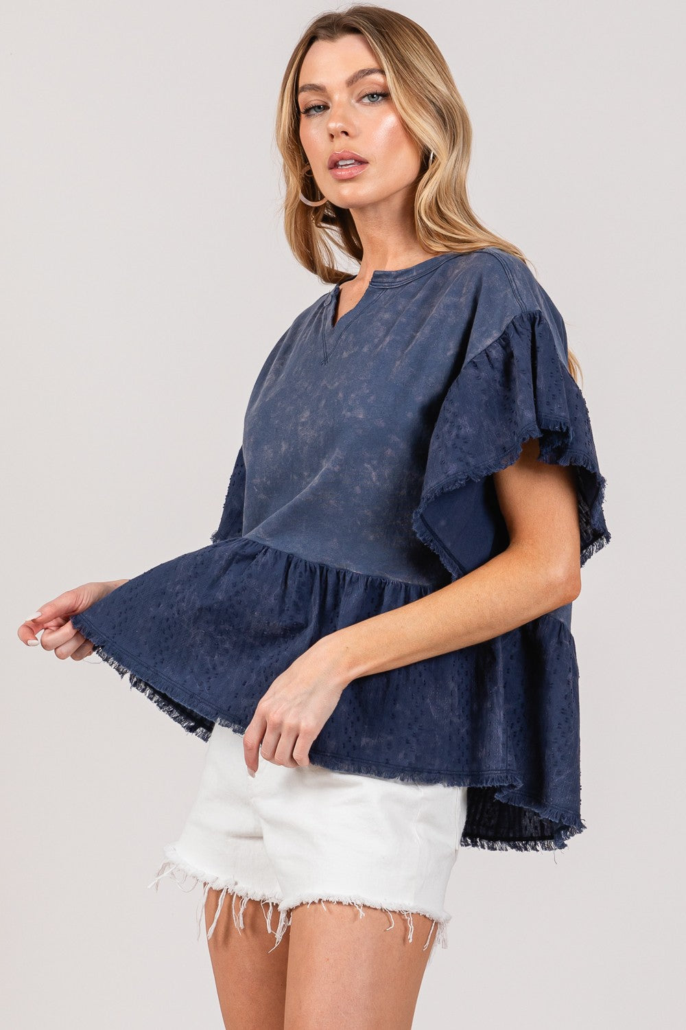 Ruffle Sleeve Washed Short Sleeve Blouse in navy worn by a model.